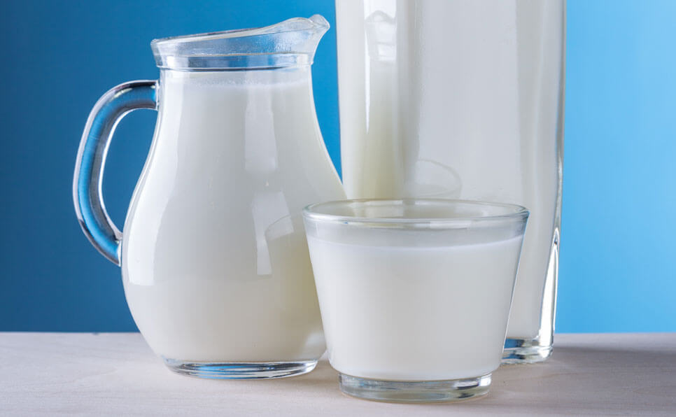 a glass and pitcher of milk